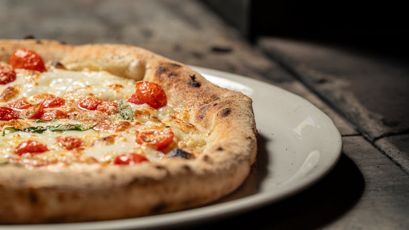 Classic Margherita pizza with fresh basil and mozzarella